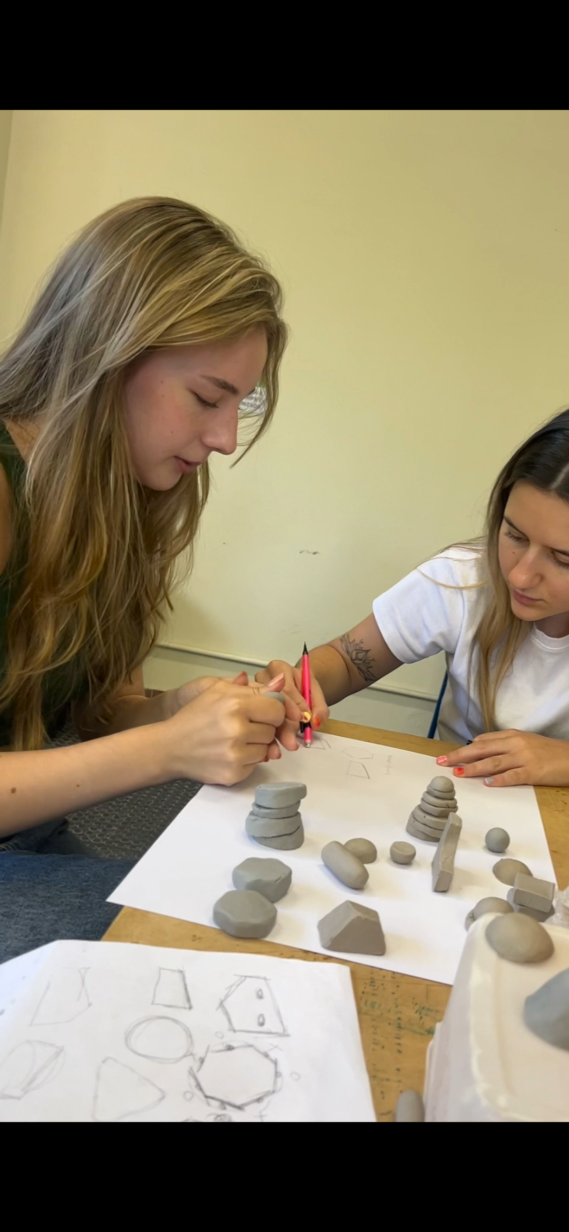 Designers sculpting clay models of monster pieces